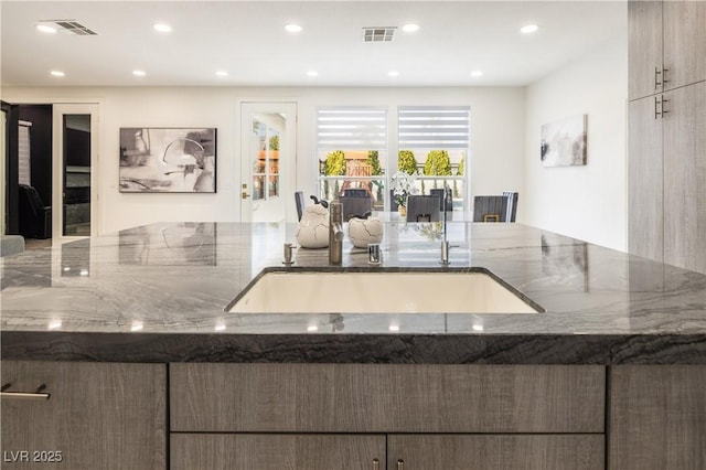 8000 Clock Tower Ct, Las Vegas, NV 89117 - kitchen with stone countertops, open floor plan, and recessed lighting