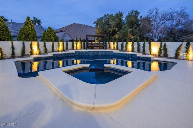 view of pool featuring a fenced backyard and a pool with connected hot tub