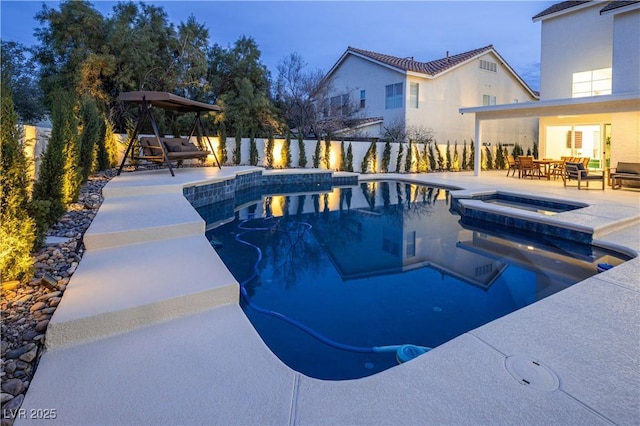 view of swimming pool featuring an in-ground hot tub, a patio, a fenced backyard, and outdoor dining area