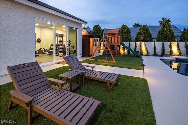 view of playground with a patio area
