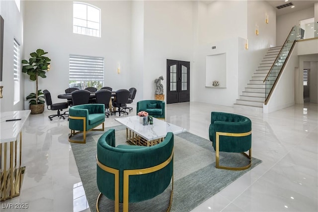 building lobby featuring a towering ceiling and stairway