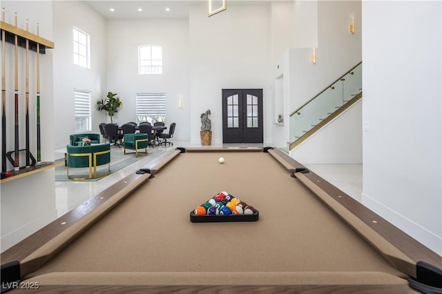 game room featuring french doors, a towering ceiling, pool table, baseboards, and recessed lighting