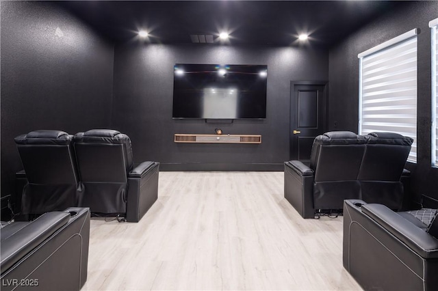 home theater room featuring wood finished floors