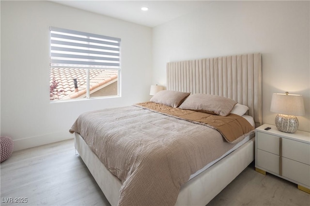 bedroom with light wood-style floors and recessed lighting