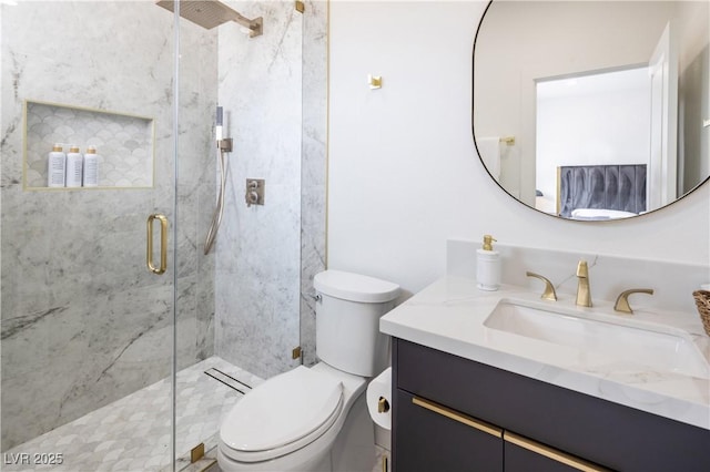 bathroom with a marble finish shower, toilet, and vanity