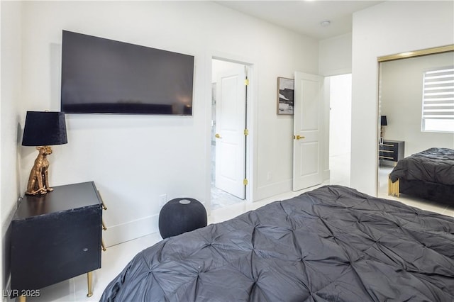 bedroom featuring baseboards and a closet