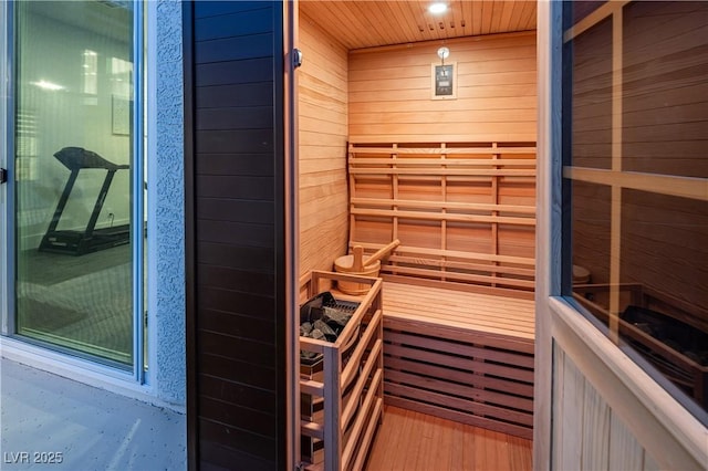 relaxing sauna / steam room featuring wooden walls and wood finished floors