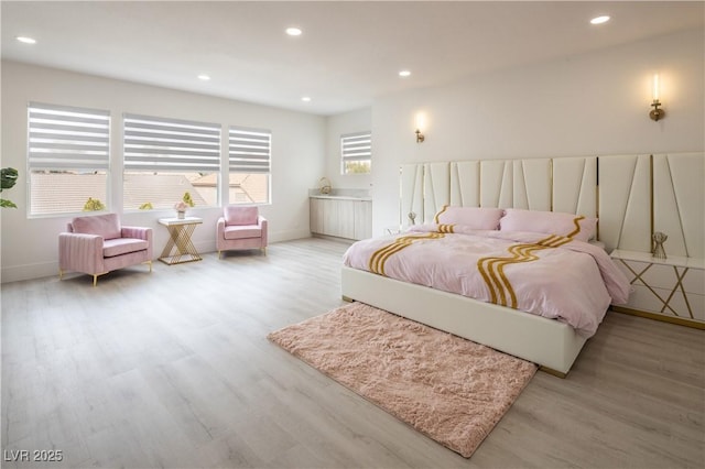 bedroom with light wood finished floors, recessed lighting, and baseboards
