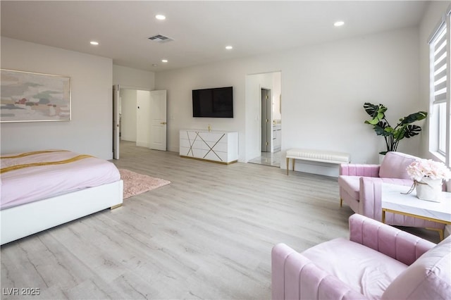 living area with wood finished floors and recessed lighting
