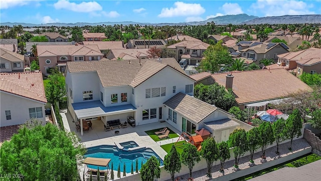 aerial view of residential area featuring mountains and a pool area