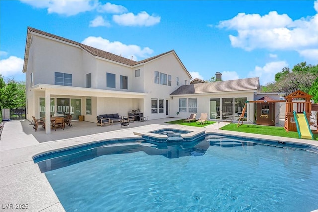 rear view of house featuring a playground, a patio area, outdoor lounge area, stucco siding, and fence