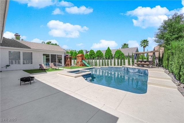view of pool with a fire pit, a playground, a patio area, fence, and a pool with connected hot tub