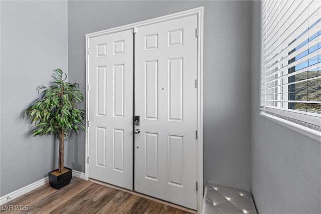 entryway featuring wood finished floors and baseboards