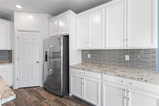 kitchen featuring dark wood-type flooring, white cabinetry, backsplash, and stainless steel fridge