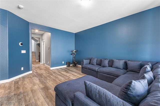 living area featuring baseboards and wood finished floors