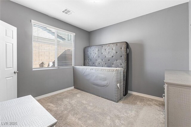 bedroom with baseboards, visible vents, and carpet floors