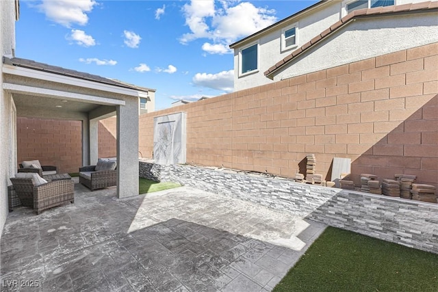 view of patio featuring a fenced backyard and an outdoor living space