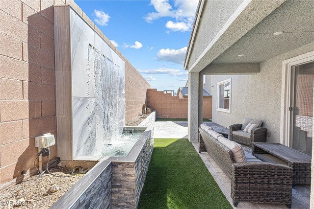 view of yard featuring a patio, an outdoor living space, and a fenced backyard