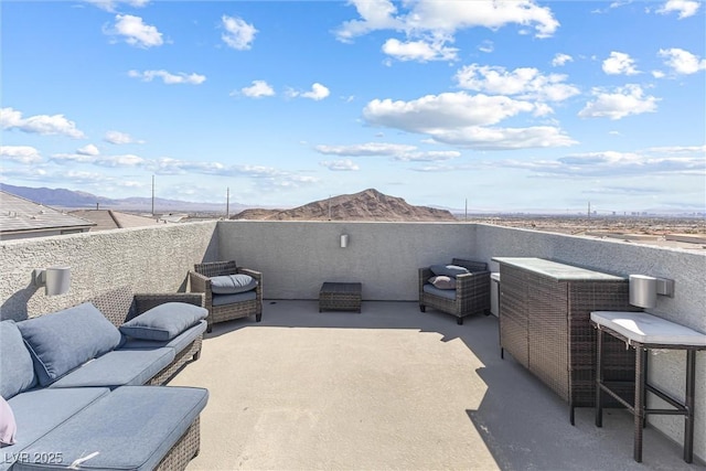 view of patio / terrace featuring an outdoor living space and a mountain view