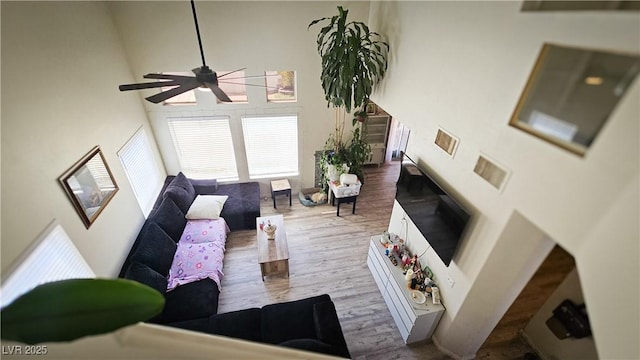 3871 Sir Bret Ct, Las Vegas, NV 89104 - living area with a ceiling fan, a towering ceiling, and wood finished floors