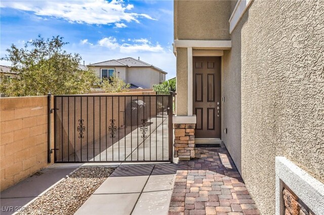 415 Carsin Wayne Ct, North Las Vegas, NV 89031 - entrance to property featuring stucco siding and a gate