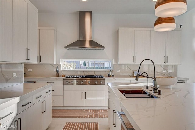 12199 Canyon Sunset St, Las Vegas, NV 89138 - kitchen with tasteful backsplash, light stone countertops, stainless steel gas cooktop, wall chimney exhaust hood, and a sink