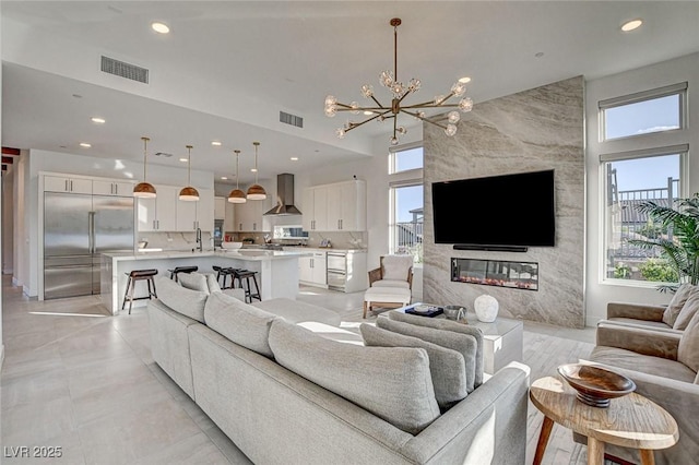 12199 Canyon Sunset St, Las Vegas, NV 89138 - living area with recessed lighting, a towering ceiling, visible vents, and an inviting chandelier