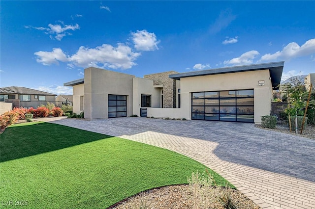12199 Canyon Sunset St, Las Vegas, NV 89138 - contemporary home featuring stucco siding, decorative driveway, a front yard, a garage, and fence