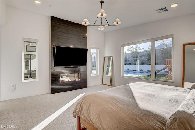 12199 Canyon Sunset St, Las Vegas, NV 89138 - bedroom with an inviting chandelier, a multi sided fireplace, visible vents, recessed lighting, and carpet flooring