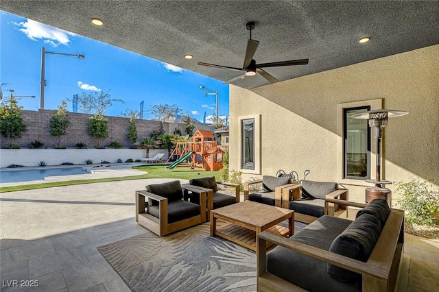12199 Canyon Sunset St, Las Vegas, NV 89138 - view of patio / terrace featuring a fenced backyard, a playground, an outdoor hangout area, and a ceiling fan