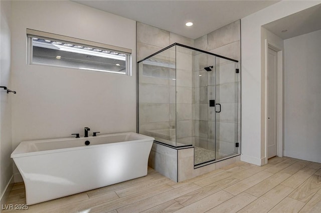12199 Canyon Sunset St, Las Vegas, NV 89138 - full bath with baseboards, wood tiled floor, a stall shower, and a soaking tub