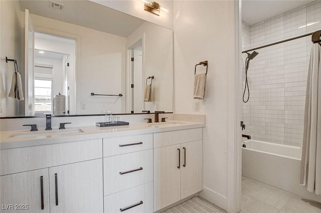 12199 Canyon Sunset St, Las Vegas, NV 89138 - bathroom featuring washtub / shower combination, double vanity, visible vents, and a sink