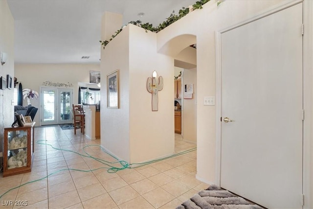 1066 Vanlier Ln, Henderson, NV 89015 - hall featuring arched walkways, light tile patterned floors, and baseboards