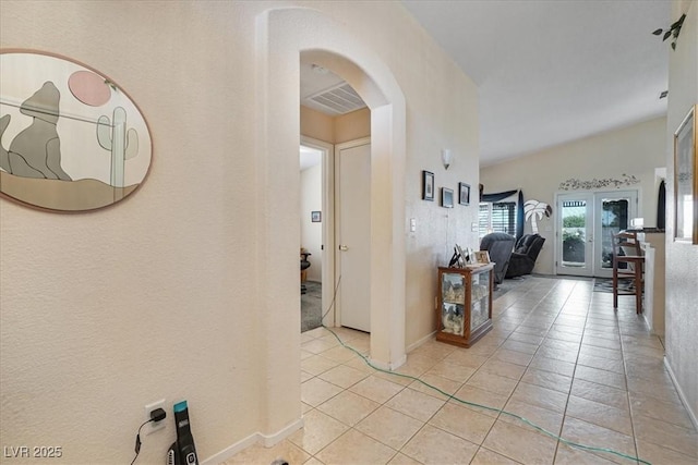 1066 Vanlier Ln, Henderson, NV 89015 - corridor featuring arched walkways, light tile patterned flooring, and baseboards