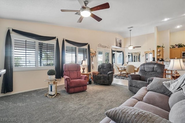 1066 Vanlier Ln, Henderson, NV 89015 - carpeted living area featuring a ceiling fan, baseboards, and lofted ceiling