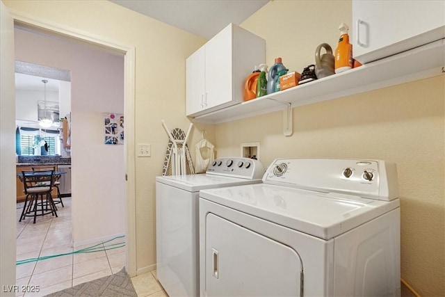 1066 Vanlier Ln, Henderson, NV 89015 - clothes washing area featuring separate washer and dryer, cabinet space, and light tile patterned floors