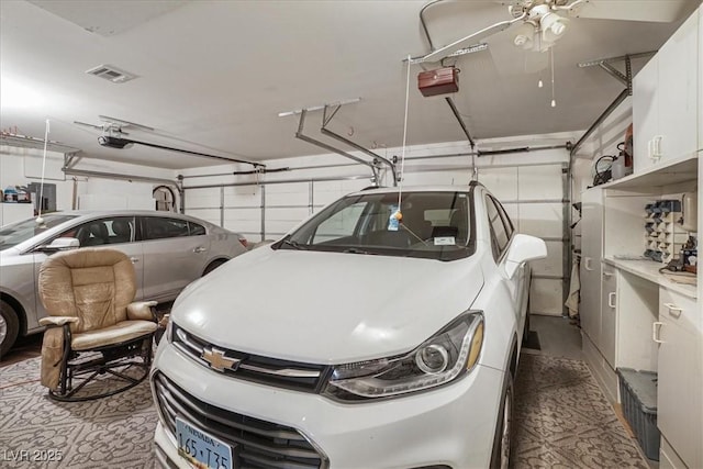 1066 Vanlier Ln, Henderson, NV 89015 - garage featuring a garage door opener and ceiling fan