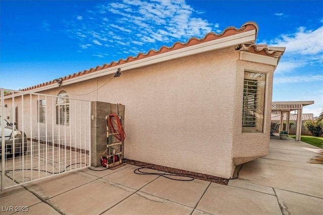 1066 Vanlier Ln, Henderson, NV 89015 - view of side of property featuring stucco siding and a patio area