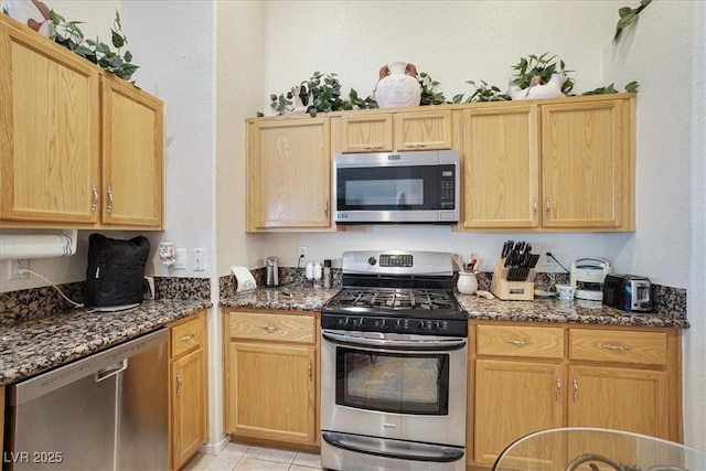 1066 Vanlier Ln, Henderson, NV 89015 - kitchen featuring stainless steel appliances, dark stone countertops, and light brown cabinets