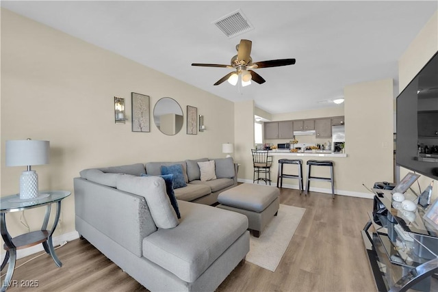 5530 Berchmans Ave, Las Vegas, NV 89122 - living area featuring light wood finished floors, baseboards, a ceiling fan, and visible vents