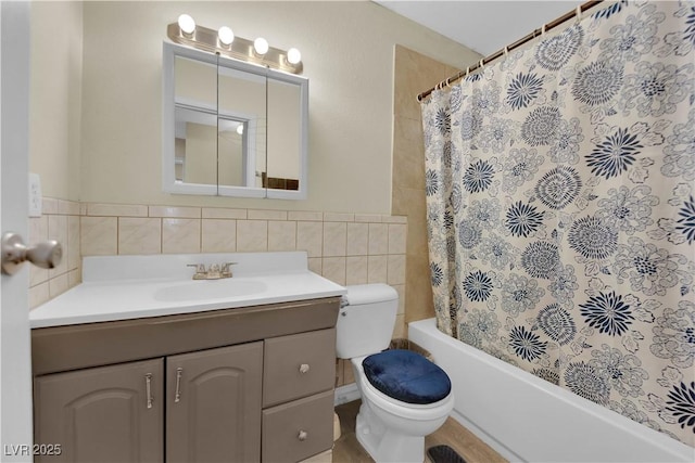 5530 Berchmans Ave, Las Vegas, NV 89122 - full bathroom featuring shower / bath combination with curtain, toilet, vanity, tile walls, and wainscoting