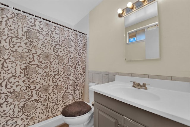 5530 Berchmans Ave, Las Vegas, NV 89122 - full bathroom featuring toilet, a shower with curtain, vanity, and tile walls