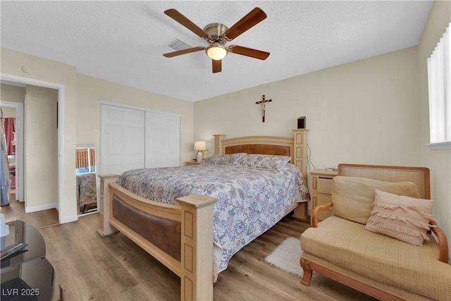 5530 Berchmans Ave, Las Vegas, NV 89122 - bedroom with visible vents, wood finished floors, a closet, and ceiling fan