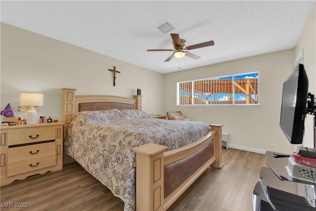 5530 Berchmans Ave, Las Vegas, NV 89122 - bedroom featuring wood finished floors, visible vents, a ceiling fan, and baseboards