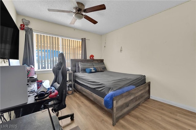5530 Berchmans Ave, Las Vegas, NV 89122 - bedroom with baseboards, a ceiling fan, wood finished floors, and a textured ceiling