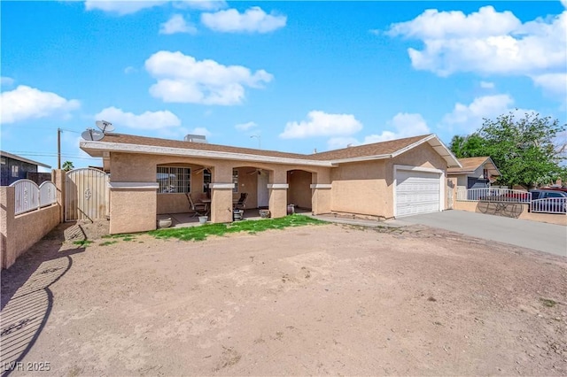 5530 Berchmans Ave, Las Vegas, NV 89122 - ranch-style home with a gate, an attached garage, concrete driveway, and stucco siding