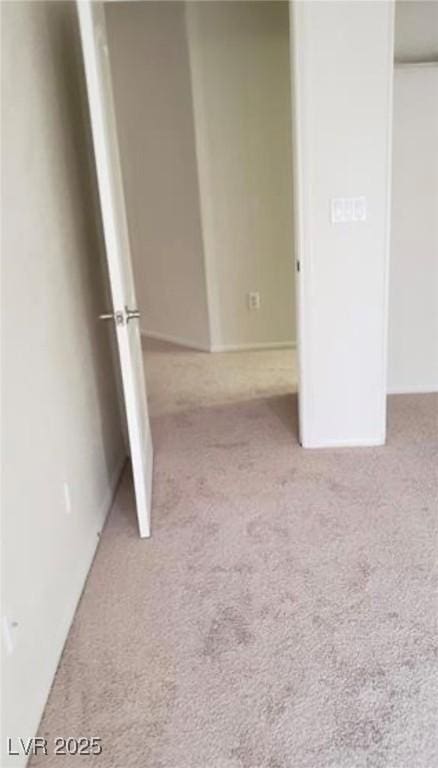 unfurnished bedroom featuring carpet flooring and a closet