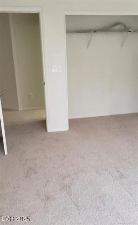 unfurnished bedroom featuring a closet and carpet flooring