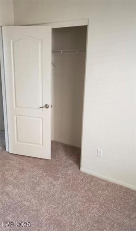 unfurnished bedroom featuring a closet and carpet flooring