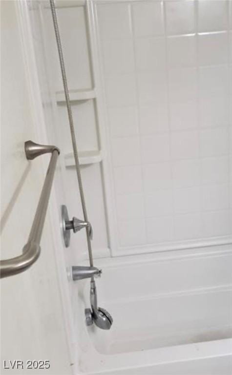 interior details featuring tub / shower combination